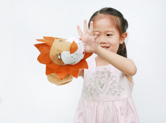 Adorable little Asian child girl hand wear and playing Lion puppets on white background.