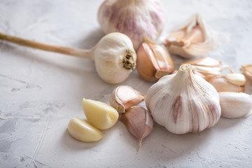 Group of garlic cloves scattered on a white background. Important ingredient in cuisines of the world. Healthy product.