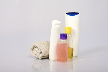 Fototapeta na wymiar Plastic bottles of body care and beauty products on white background