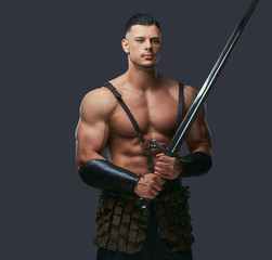 Brutal ancient Greece warrior with a muscular body in battle uniforms