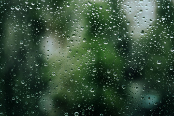 Aquamarine freshness after the rain. The texture of the drops on the glass.
