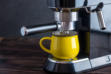 Preparation of espresso. Coffee pours from the coffee machine into the Cup. Professional coffee brewing