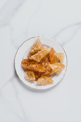 elevated view of plate with honeycombs on marble table