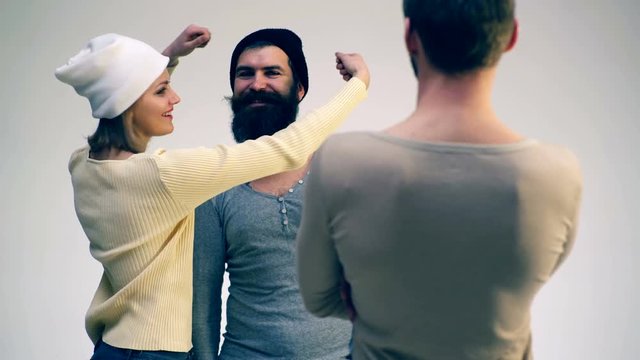 The guy and the girl boast of a mustache in front of a friend. Concept of fun communication. Girl twists her friend's mustache.