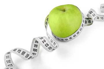 Body Measuring Tape Around A Green Apple