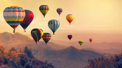 Fotobehang Ballon Heteluchtballon boven hoge berg bij zonsondergang