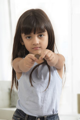 Portrait of girl holding coin