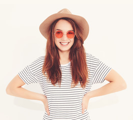 Portrait of young stylish laughing girl model in casual summer clothes in brown hat with natural makeup isolated on white background. In sunglasses.