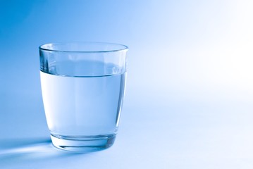 Glass of water in blue