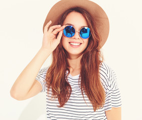 Portrait of young stylish laughing girl model in casual summer clothes in brown hat isolated on...