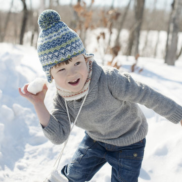 Boy throwing snowball