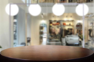 Selected focus empty brown wooden table and Coffee shop or restaurant blur background with bokeh image. for your photomontage or product display