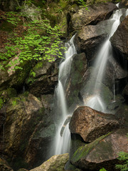 Waterfall, cascade between big rocks in ravine Ysperklamm