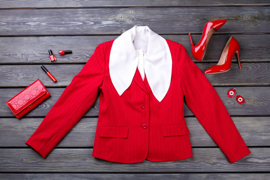 Red female blazer and accessories. Flat lay glamour red clothing, shoes and wallet.