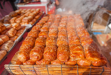 Steaming bread and bacon sprinkle with white sesame seeds.