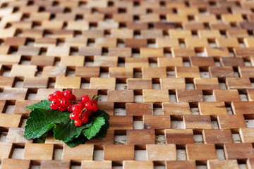 Ripe red currant berries and leaves on light background