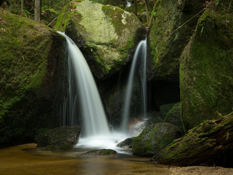 Waterfall, cascade between big rocks in ravine Ysperklamm
