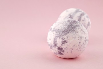 Lavender bath bombs on a gently pink background.Aromatherapy and body cosmetics.natural vegan organic body cosmetics
