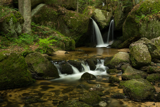 Waterfall, cascade between big rocks in ravine Ysperklamm