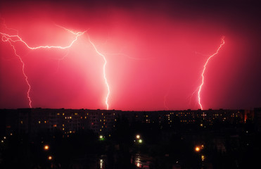 Lightning strikes down over the city at night. Beautiful shot. Long Exposure Photography