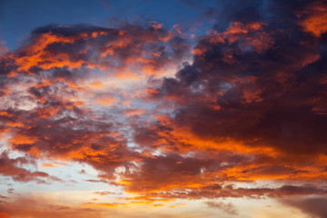 Beautiful bright colorful sky. Picture taken at sunset. Red-orange background with nice paints. Rare sunrise. Natural composition