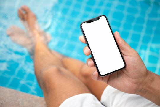 man at the pool holding phone with an isolated screen