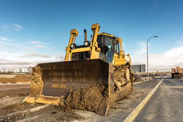 Obraz na płótnie Canvas Excavator performing repairs of a road