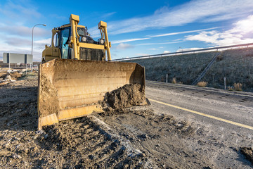 Excavator performing repairs of a road