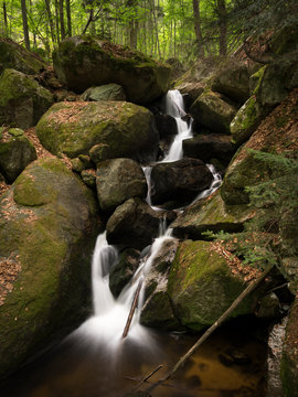 Waterfall, cascade between big rocks in ravine Ysperklamm