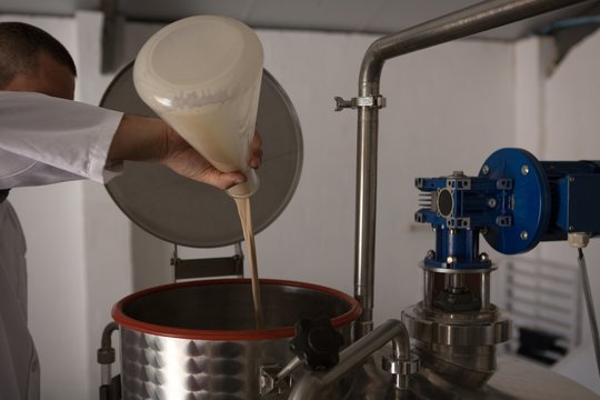 Worker checking quality of gin