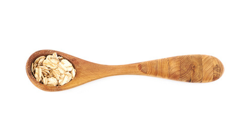 Wooden spoon of oatmeal flakes isolated