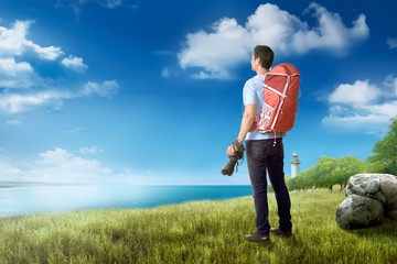 Back view of asian traveler man with camera and backpack