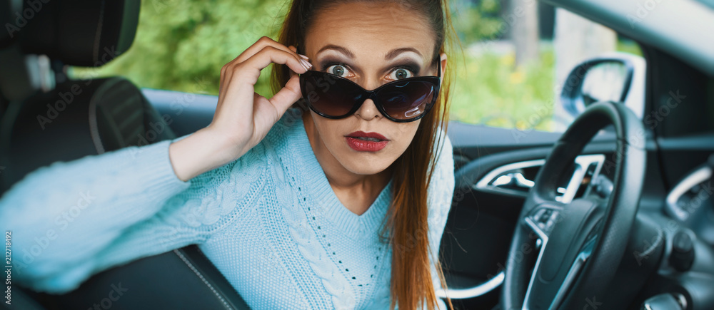 Wall mural shocked young woman in the car