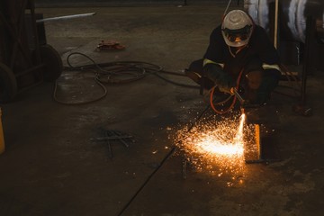 Welder repairing vessel part