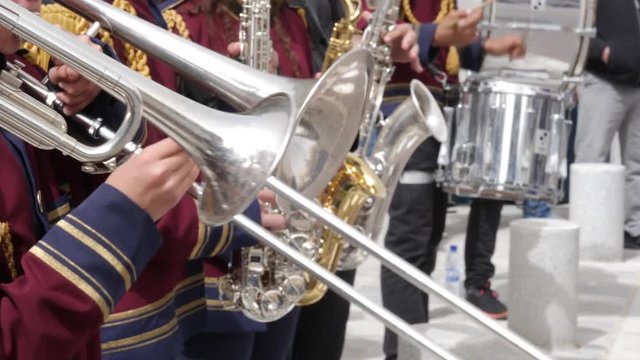 Close of various intruments being played by a marching band
