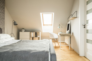Real photo of bright Nordic style attic room interior with woode - obrazy, fototapety, plakaty