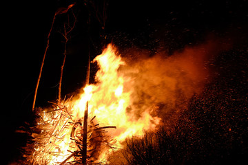 big camp fire burns at night