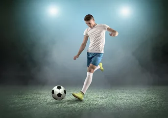 Outdoor kussens Soccer player on a football field in dynamic action at summer day © Andrii IURLOV