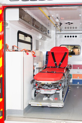 inside a first aid red vehicle with the stretcher