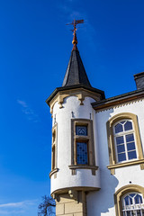 Fototapeta na wymiar Architectural detail from Urspelt Castle in Urspelt, Grand Duchy of Luxembourg against a clear deep blue sky