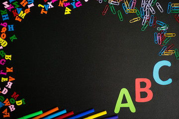 Back to school background. Top view of school supplies on chalkboard.