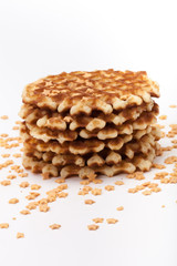 Stack of round waffles on white background with many stars