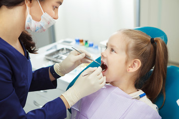 Child lies in dentist chair and goes through procedure