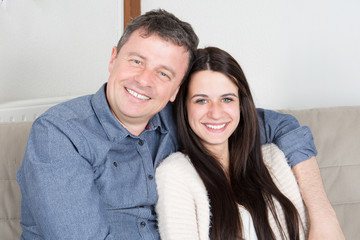 pretty cute Teenager girl sitting on couch home with father