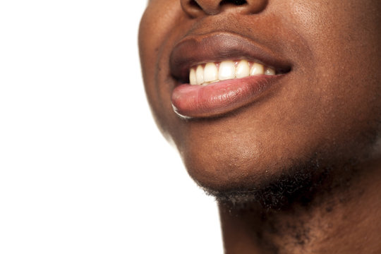 Smile closeup of young black african american guy on white background