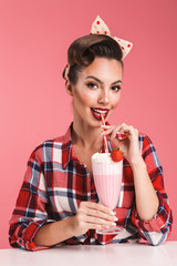 Portrait of a happy brunette pin-up girl in plaid shirt