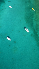 Aerial drone bird's eye view photo of traditional docked fishing boats in chora of island of Mykonos, Cyclades, Greece