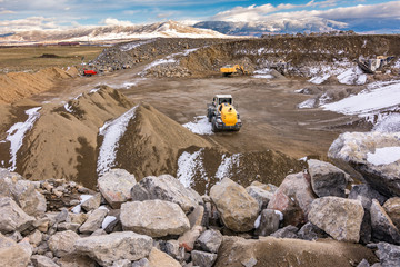 Excavator moving stone in an open pit mine in Spain