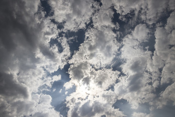 Summer sky with puffy dark clouds