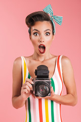 Portrait of a shocked brunette pin-up girl in plaid shirt